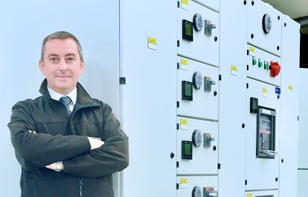 Damien Kane pictured beside engineering equipment 